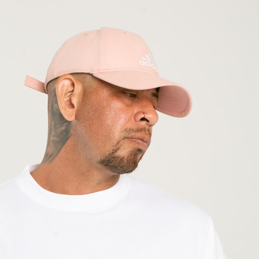 Antonio Ulloa wearing a blush pink colored baseball cap